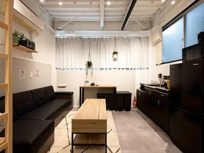 a living room with a couch and a table at Eden House - Vacation STAY 16712 in Tokyo