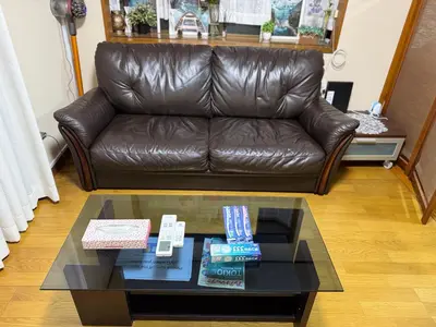 a leather couch in a living room with a coffee table at 3 bedrooms entire house in Tokyo