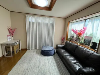 a living room with a leather couch and a window at 3 bedrooms entire house in Tokyo
