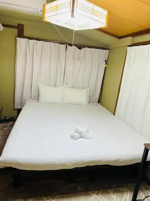 a bedroom with a bed with a towel on it at 3 bedrooms entire house in Tokyo
