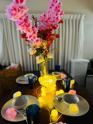 a table with a vase filled with pink flowers at 3 bedrooms entire house in Tokyo