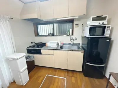 a small kitchen with a sink and a microwave at 3 bedrooms entire house in Tokyo