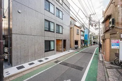 an empty street in a city with buildings at 67 Apt \u677f\u6a4b\u672c\u753a in Tokyo