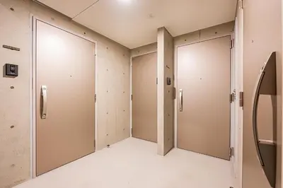 a row of elevator doors in a room at 67 Apt \u677f\u6a4b\u672c\u753a in Tokyo