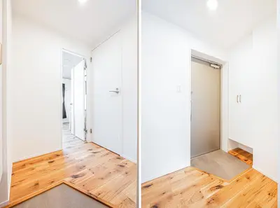 a hallway with white walls and wood floors and a mirror at 67 Apt \u677f\u6a4b\u672c\u753a in Tokyo