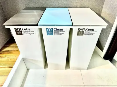 two white trash cans sitting next to each other at Hokusai's House Shibuya Dogenzaka 311 in Tokyo