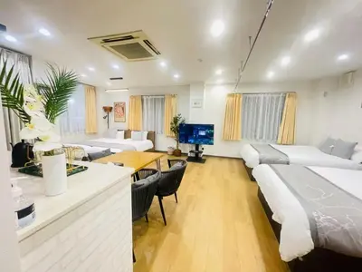 a living room with two beds and a dining room at \u6771\u7530\u7aef2F-kKI0064 in Tokyo
