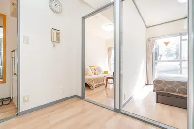 a sliding glass door in a room with a bedroom at Shinjuku Takadanobaba 6 mins walk 2BR Room201 in Tokyo