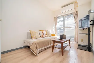 a living room with a couch and a table at Shinjuku Takadanobaba 6 mins walk 2BR Room201 in Tokyo