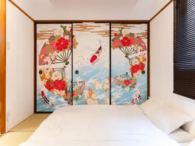 a bedroom with a bed and a painting of flowers at Shinjuku,Ushigome Yanagicho Sta 1min walk , Kabukicho3min in Tokyo