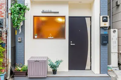 a house with a black door and a window at \u65ed \u30cf\u30a6\u30b9\u3000asahi house in Tokyo