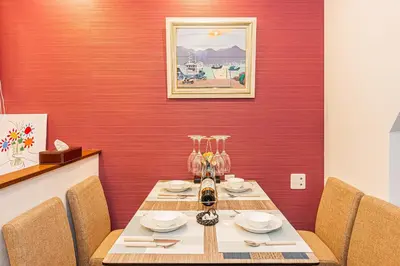 a table in a room with a red wall at \u65ed \u30cf\u30a6\u30b9\u3000asahi house in Tokyo