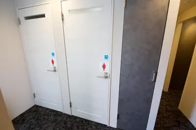 a locker room with white doors in a room at smart room tokyo koiwa city in Tokyo