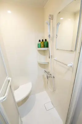 a white bathroom with a shower and a toilet at smart room tokyo koiwa city in Tokyo