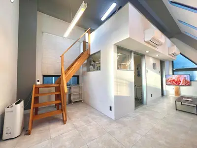 a living room with a staircase in a house at Aizumi Hostel-SJ0193 in Tokyo