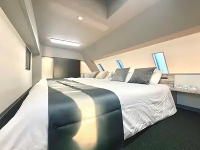 a large white bed in a room with windows at Aizumi Hostel-SJ0193 in Tokyo