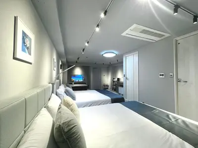 a hotel room with two beds and a television at Aizumi Hostel-SJ0193 in Tokyo