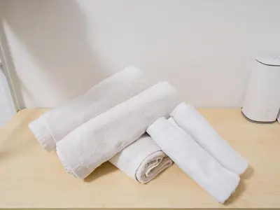 a pile of towels sitting on top of a table at Shin-Okubo Sta・1 min walk/　Shinjuku sta 2min/　Switch in Tokyo