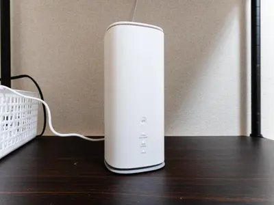 a white router sitting on a wooden table at Shin-Okubo Sta・1 min walk/　Shinjuku sta 2min/　Switch in Tokyo