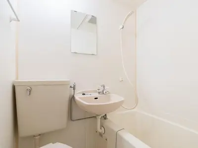a white bathroom with a sink and a mirror at Shin-Okubo Sta・1 min walk/　Shinjuku sta 2min/　Switch in Tokyo