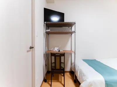 a room with a bed and a desk with a light at Shinjuku/Shin-Okubo Sta 2min walk/Kabukicho 5 min in Tokyo