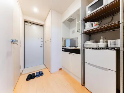 a kitchen with white cabinets and a glass door at Shinjuku/Shin-Okubo Sta 2min walk/Kabukicho 5 min in Tokyo