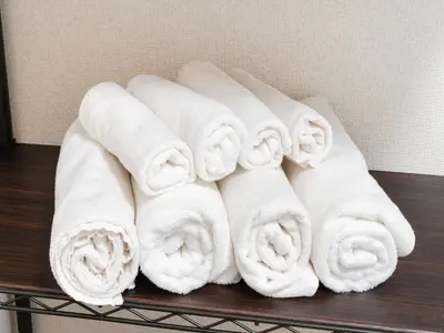 a pile of white towels sitting on a shelf at Shinjuku/Shin-Okubo Sta 2min walk/Kabukicho 5 min in Tokyo