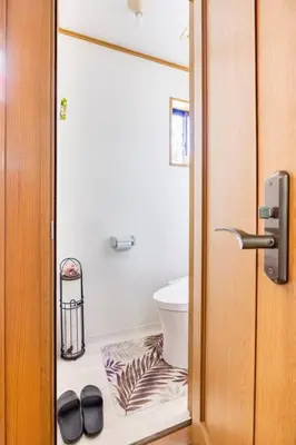 a bathroom with a toilet and a pair of shoes at \u30a2\u30f3\u30c9\u30b9\u30c6\u30a4\u7530\u7aef\uff16\u4e01\u76ee in Tokyo