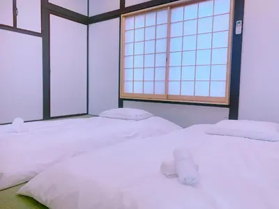 two white beds in a room with two windows at miki I in Tokyo