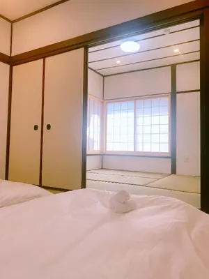 a bedroom with a white bed with a window at miki I in Tokyo