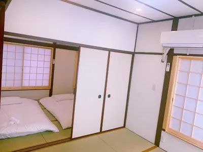 a room with two beds and a window at miki I in Tokyo