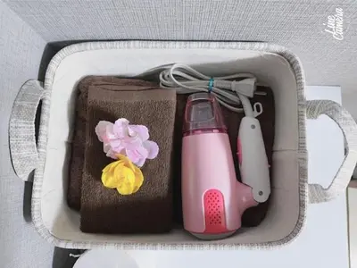 a suitcase with a pink bottle and a pink appliance at Momo palace in Tokyo