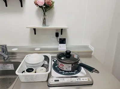 a kitchen counter with a pot on a stove at Momo palace in Tokyo