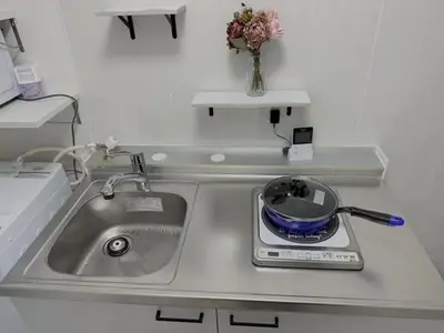 a kitchen counter with a sink and a frying pan at Momo palace in Tokyo
