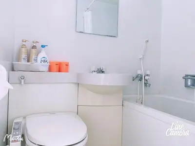 a bathroom with a toilet and a sink and a tub at Ikebukuro 706 in Tokyo