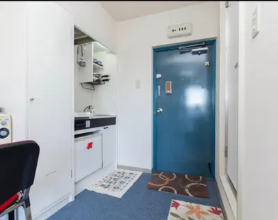 a blue door in a room with a kitchen at Ikebukuro 706 in Tokyo