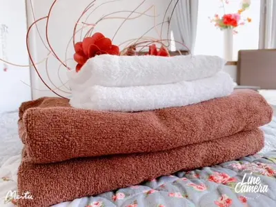a pile of towels sitting on top of a bed at Ikebukuro 706 in Tokyo
