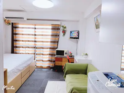 a small room with a bed and a couch at Ikebukuro 706 in Tokyo