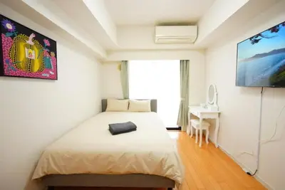 a bedroom with a large bed and a tv at \u30ec\u30b8\u30c7\u30f3\u30b7\u30e3\u30eb\u30b9\u30c6\u30fc\u30b8 in Tokyo