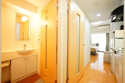 a bathroom with a sink and a mirror and a kitchen at \u30ec\u30b8\u30c7\u30f3\u30b7\u30e3\u30eb\u30b9\u30c6\u30fc\u30b8 in Tokyo