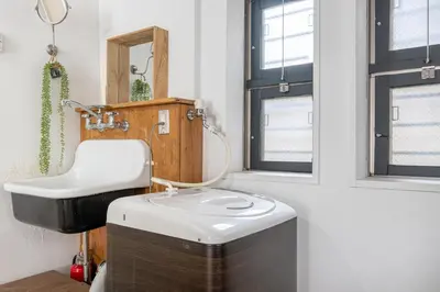 a bathroom with a sink and a mirror at Good Space Hotel Yoyogi in Tokyo