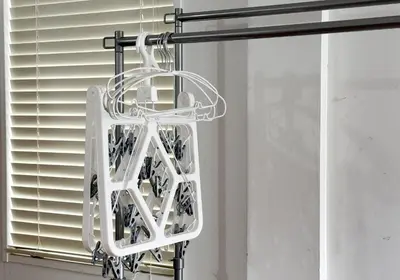 a white wine rack hanging from a window at Good Space Hotel Yoyogi in Tokyo