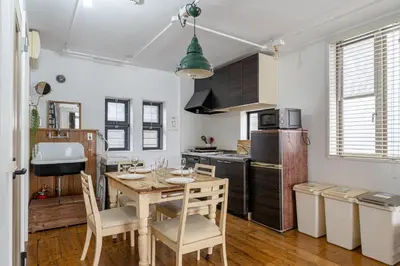a kitchen with a table and chairs in a room at Good Space Hotel Yoyogi in Tokyo