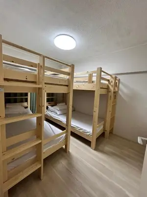 a room with two bunk beds in a room at Riverside Omori in Tokyo