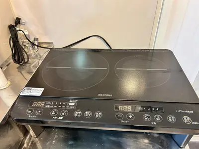 a black toaster oven sitting on top of a counter at Riverside Omori in Tokyo