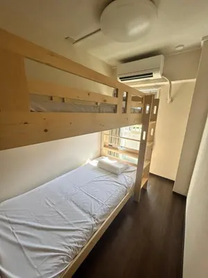a bedroom with two bunk beds in a hostel at Riverside Omori in Tokyo