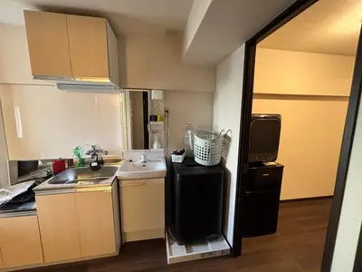 a small kitchen with a sink and a refrigerator at Riverside Omori in Tokyo