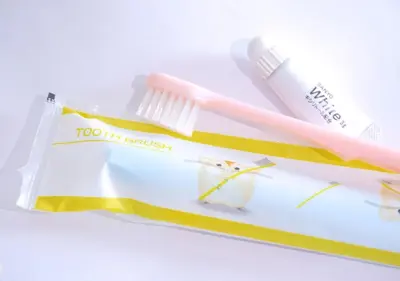 a toothbrush and toothpaste sitting on top of a package at APA Hotel Kanda Jimbocho Ekihigashi in Tokyo
