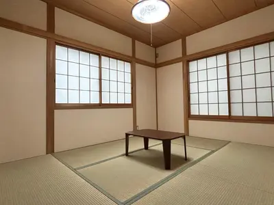 a room with a table in a room with windows at Tokyo log house with Free parking in Tokyo