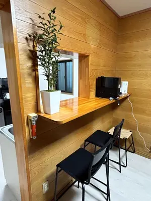 a room with two chairs and a table and a microwave at Tokyo log house with Free parking in Tokyo